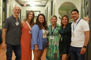 A group of six 2005 alumni in Monroe Hall.