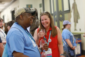 Two alumni laugh and enjoy wine tasting at the Virginia wine, beer, and cider tasting during Reunion Weekend.