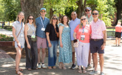 A group of alumni pose for a photo on Campus Walk during Reunion Weekend.