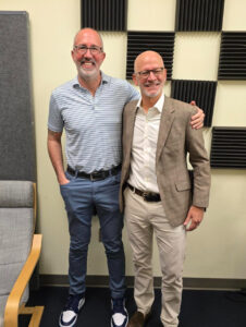 Alumnus Lou Marmo '94 and President Troy Paino standing in a podcast studio. 
