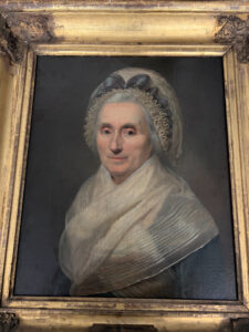 A painting of Mary Washington featuring George Washington's face painted on his mother's body.