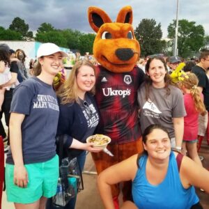 A group of four people and a kangaroo mascot.