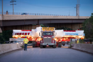 A tractor trailer transporting a giant piece of technology for a physics experiment.