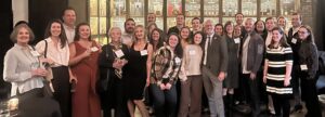 A group of people in an upscale distillery/bar.