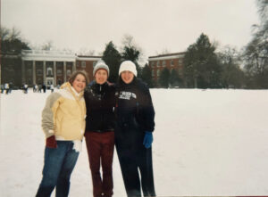 Three students in winter weather gear on Ball Circle in a 2000s photo.