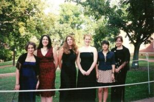 A mid-2000s photo of six students in semiformal dress on the UMW campus.